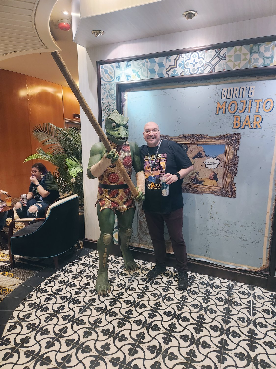 AT SEA AND ON LAND: Warwick Librarian Aaron Coutu with one of the characters he encountered on the recent cruise for Trekkies and with the Christmas tree, which he still lights in his office and decorated with Star War figures and ships.